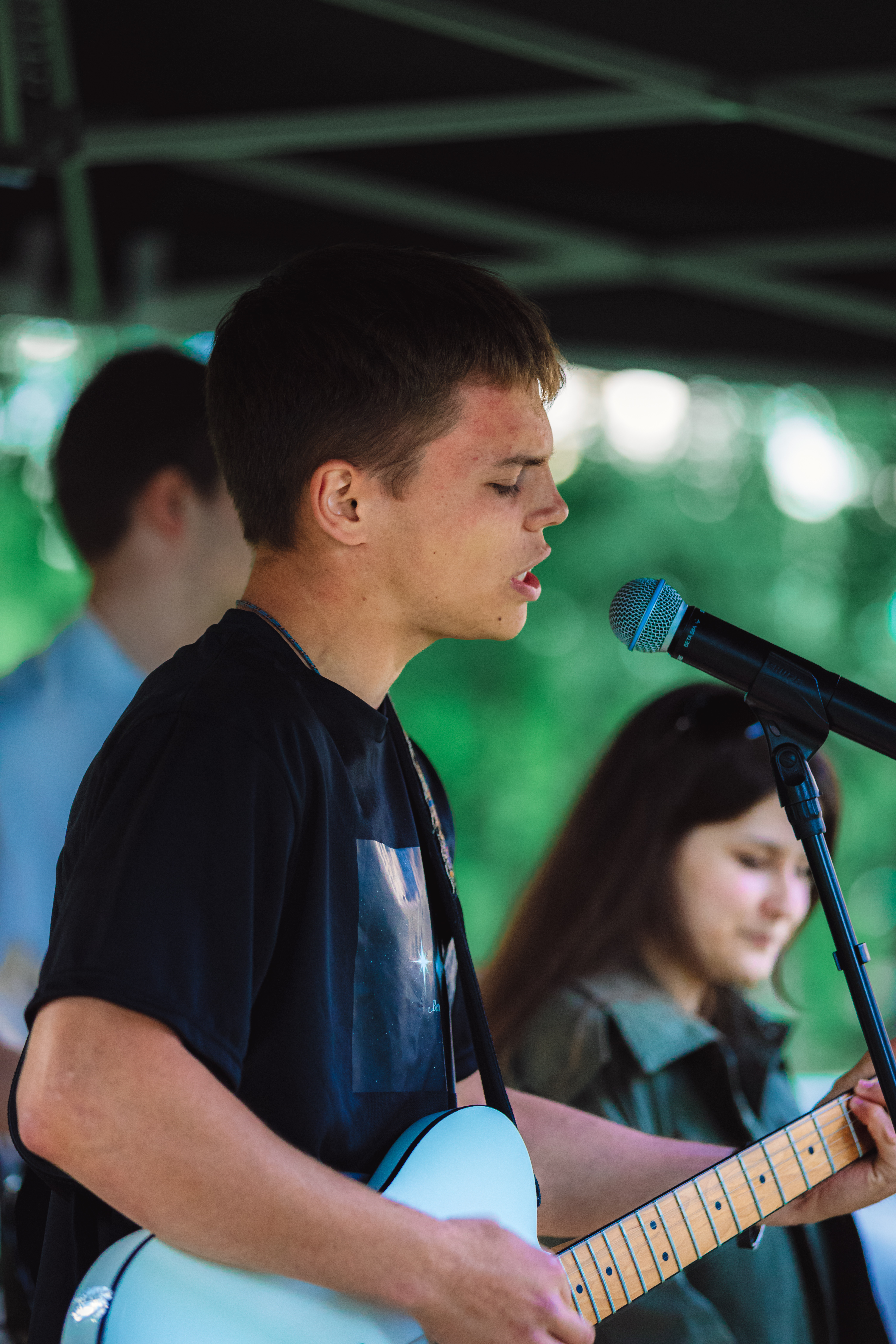 Young musician singing and playing guitar